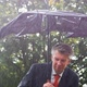 Businessman Sheltering Underneath a Broken Umbrella in the Rain - VideoHive Item for Sale