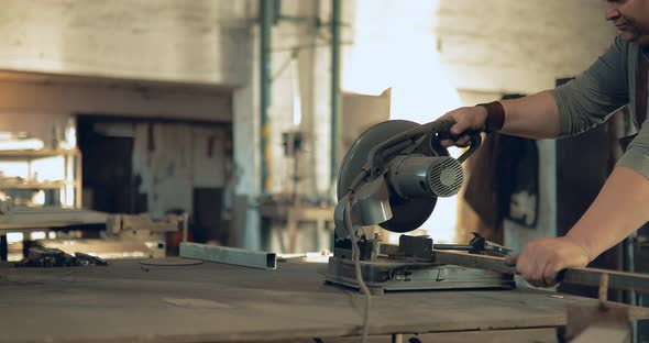 Blacksmith Saws Metal with a Circular Saw