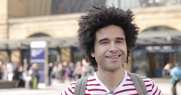 Man portrait in front of busy train station in London