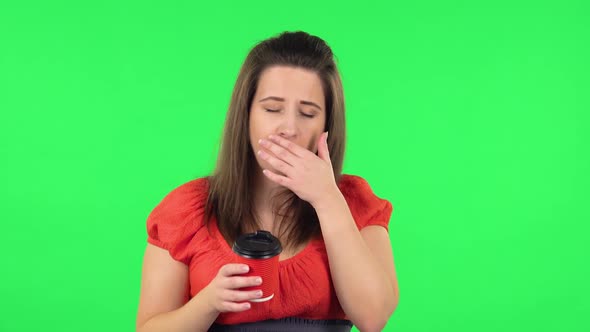 Portrait of Cute Girl Is Drinking Unpalatable Coffee and Is Disgusted. Green Screen