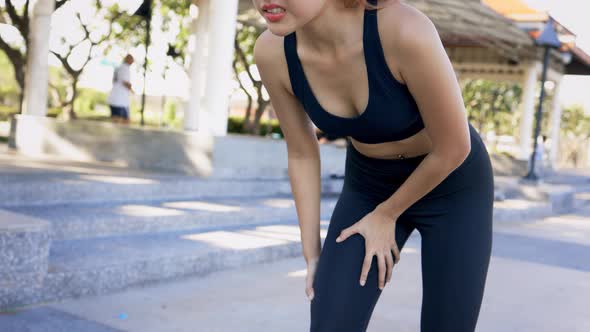 Woman Suffering From Knee Pain While Running