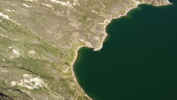 Bird eyes perspective of the edge of the Quilotoa lake a lake from an inactive vulcano in Ecuador