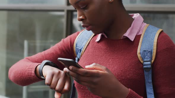 African american using her smartphone in street