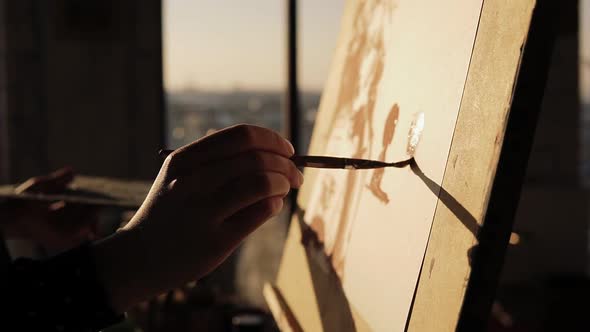 Close Up Slow Motion Footage of a Gifted Female Artist Drawing with Paint Brush on Cancas on Easel