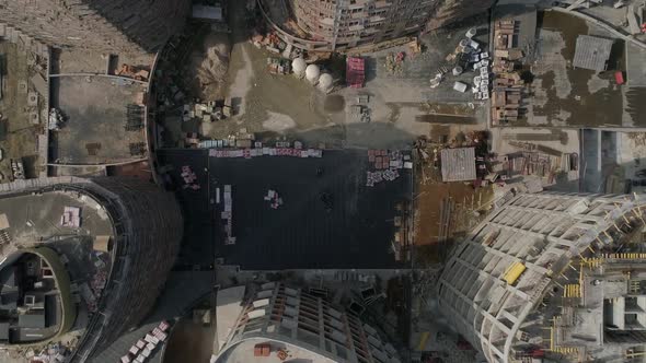 Aerial shot of construction of high-rise apartment buildings and cranes in city 04