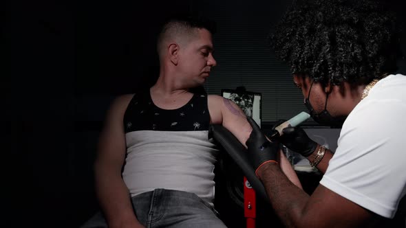 Cinematic Shot of a Tattoo Artist Creating Body Art at the Tattoo Studio