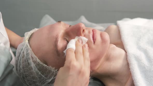 Hands of a Cosmetologist Does a Facial Massage to a Young Man