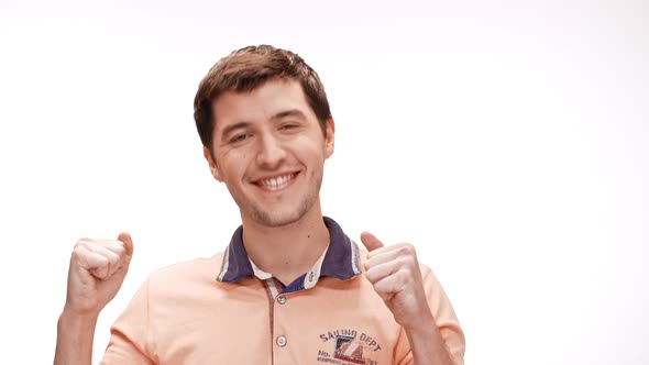 Cheerful Young Man Rejoicing Smiling Over White Background Slow Motion