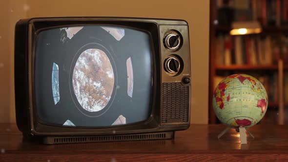 The Cupola (ISS module) and Earth as Seen on a Vintage TV near a Terrestrial Globe.