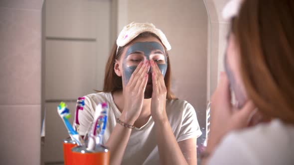 A Young Woman Washes Off the Mask From the Face