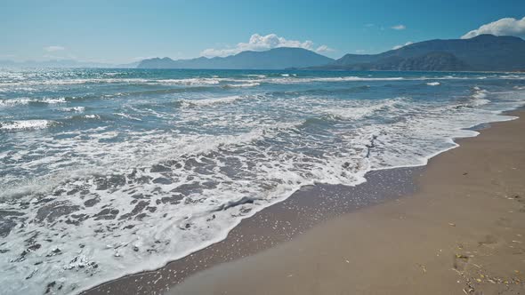 Waving Sea with Waves at Sunny Summer Windy Day at Beautiful Sandy Empty Beach Iztuzu in Turkey