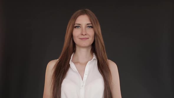 Beautiful Girl with Long Hair Standing Straight and Smiling