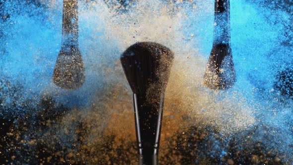 Make up brush and colored powder/particles exploding. Slow Motion. alt
