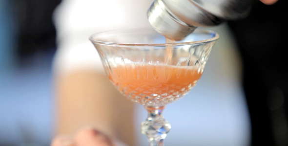 Barman Pouring Cocktail in a Glass Close up