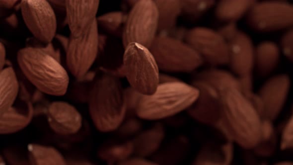 Super Slow Motion Shot of Almonds Flies After Being Exploded Against Black Background 1000Fps