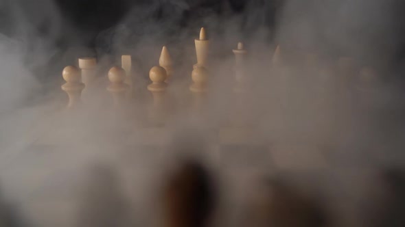 Close Up of White Chess Pieces on Board with Dissipating Steam