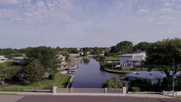 Flying Over a Bridge on Westhampton Bay by Houses with Private Docks