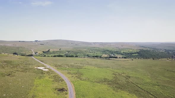 Panorama view of Dartmoor national park. Road cutting through English national park.