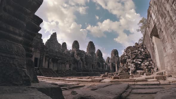 Timelapse of Temple at Angkor Wat Complex with Blue Skies, Clouds and Piles of Rocks