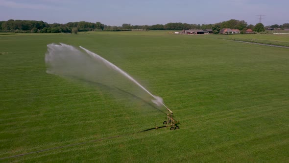 Watering an agricultural field with water sprinkler in area the Achterhoek in the Netherlands