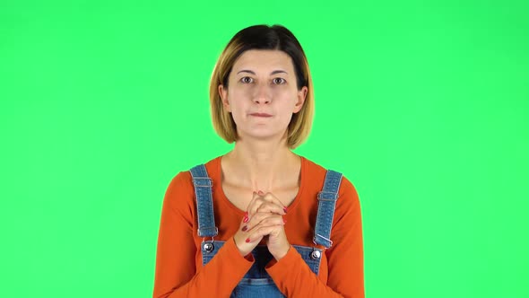 Female Stands Worrying in Expectation Then Smiles with Relief, Carried. Green Screen