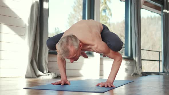 Mature Man Amongst Doing Power Yoga Exercises