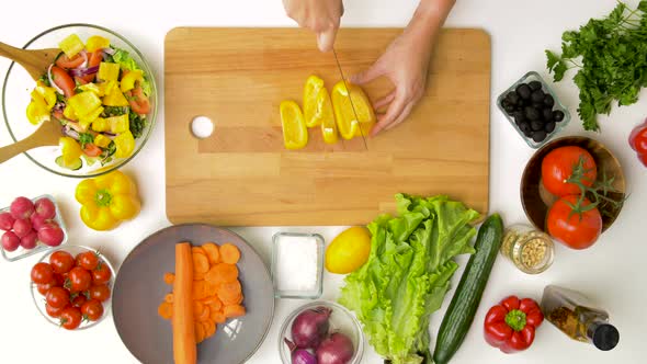 Young Woman Chopping Pepper for Salad at Home