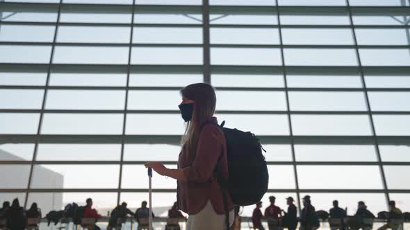 Woman in mask waiting for the flight