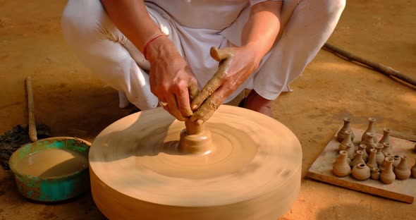 Skilled Hands of Potter Shaping the Clay on Potter Wheel and Sculpting Clay Pot Jar. Shilpagram