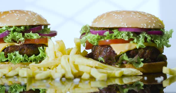 Fresh Hamburgers with French Fries and Salt in the Reflected white Light from the Window.