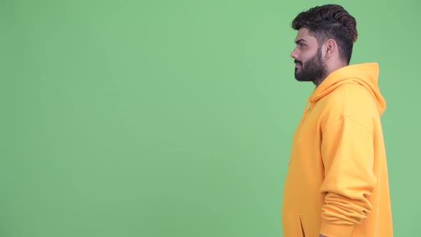 Profile View of Happy Young Overweight Bearded Indian Man Smiling