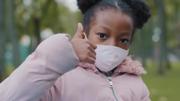 Portrait in City Little Serious African American Girl Afro Child Kid Stands on Street Outdoors