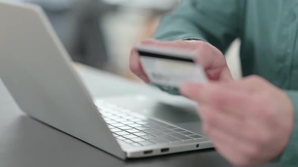 Close Up of Hands of Man Doing Online Shopping on Laptop