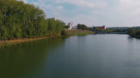 The Drone Flies Over the Water of the City Lake on the Shore of Which There is an Old Fortress with