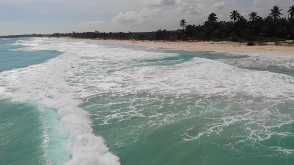 Blue Water is Foaming As the Waves are Hitting the Shore of Dominican Republic