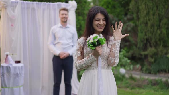 Portrait of Cheerful Excited Middle Eastern Newlywed Bride Boasting Wedding Ring on Finger Looking