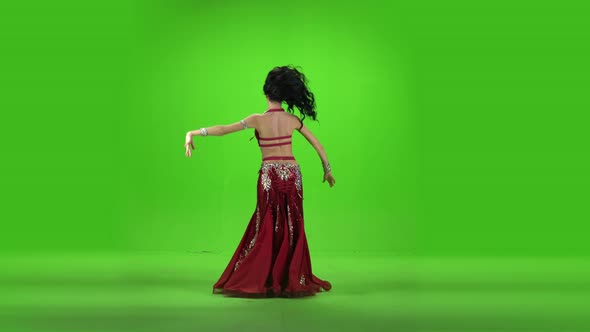 Beautiful Belly Dancer Dancing Ethnic Dances Against Green Screen.