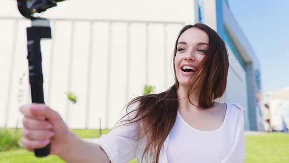 Video blogger. Woman filming vlog on camera at street