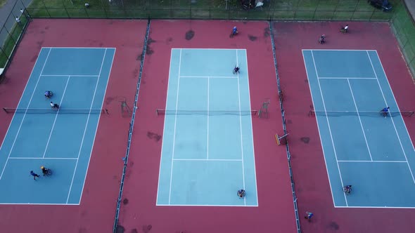 People in wheelchair playing tennis on court. Wheel Chair Tennis For Disabled. Aerial drone footage