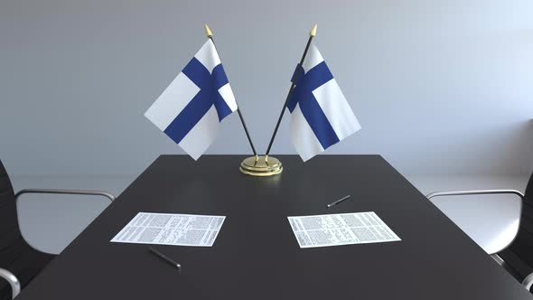 Flags of Finland and Papers on the Table