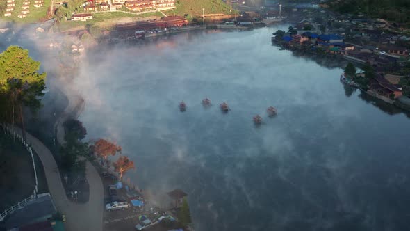 Aerial View of Sunrise with Fog Over Ban Rak Thai Chinese Village Near a Lake in Mae Hong Son