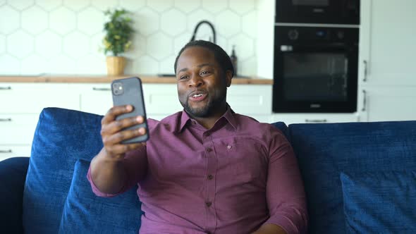 Black Man Using Smartphone for Video Call
