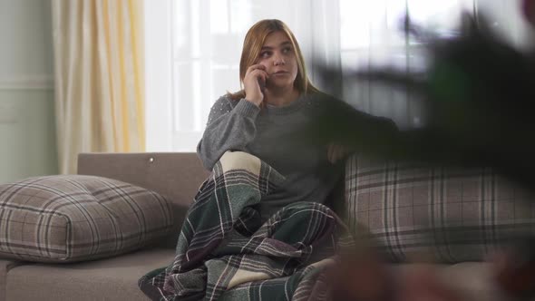 Plus Size Young Woman Smiling While Speaking on Smartphone