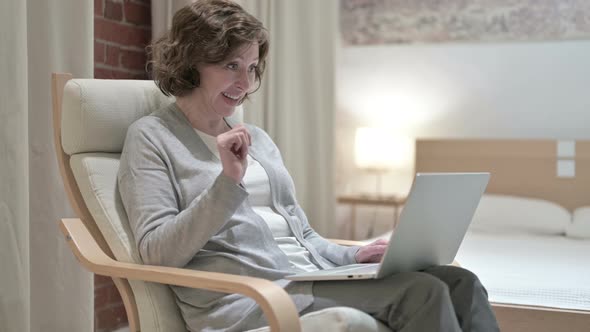 Old Woman Doing Video Chat on Laptop on Sofa