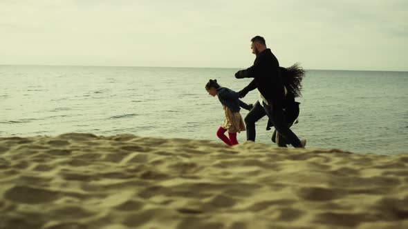 Playful Family Running Beach Sand