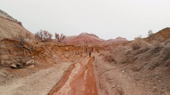 Drone Shot of Bicyclist Ride in Canyon Desert Mountains in Kazakhstan