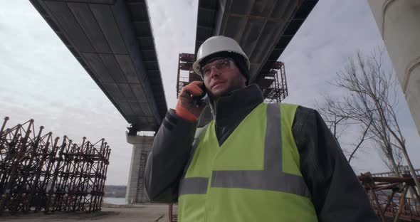 Male Contractor Speaking on Smartphone