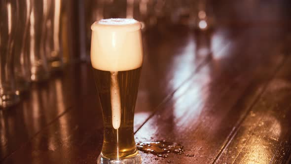 Pouring Fresh Beer From a Barrel Into a Glass