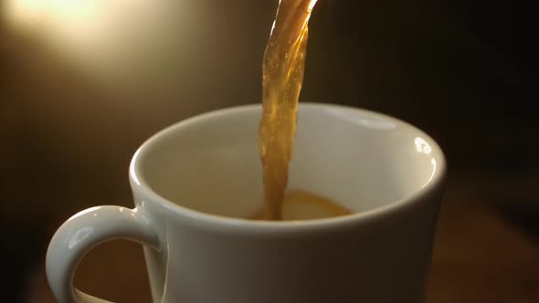 Slowmotion Closeup Shot of Hot Coffee Poured on White Cup