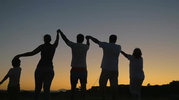 Big friendly family walking outdoor at sunset